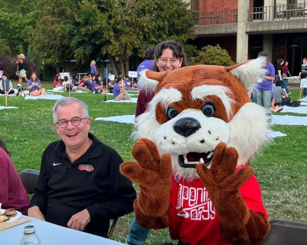 President Thorsett with Blitz at an outdoor event.